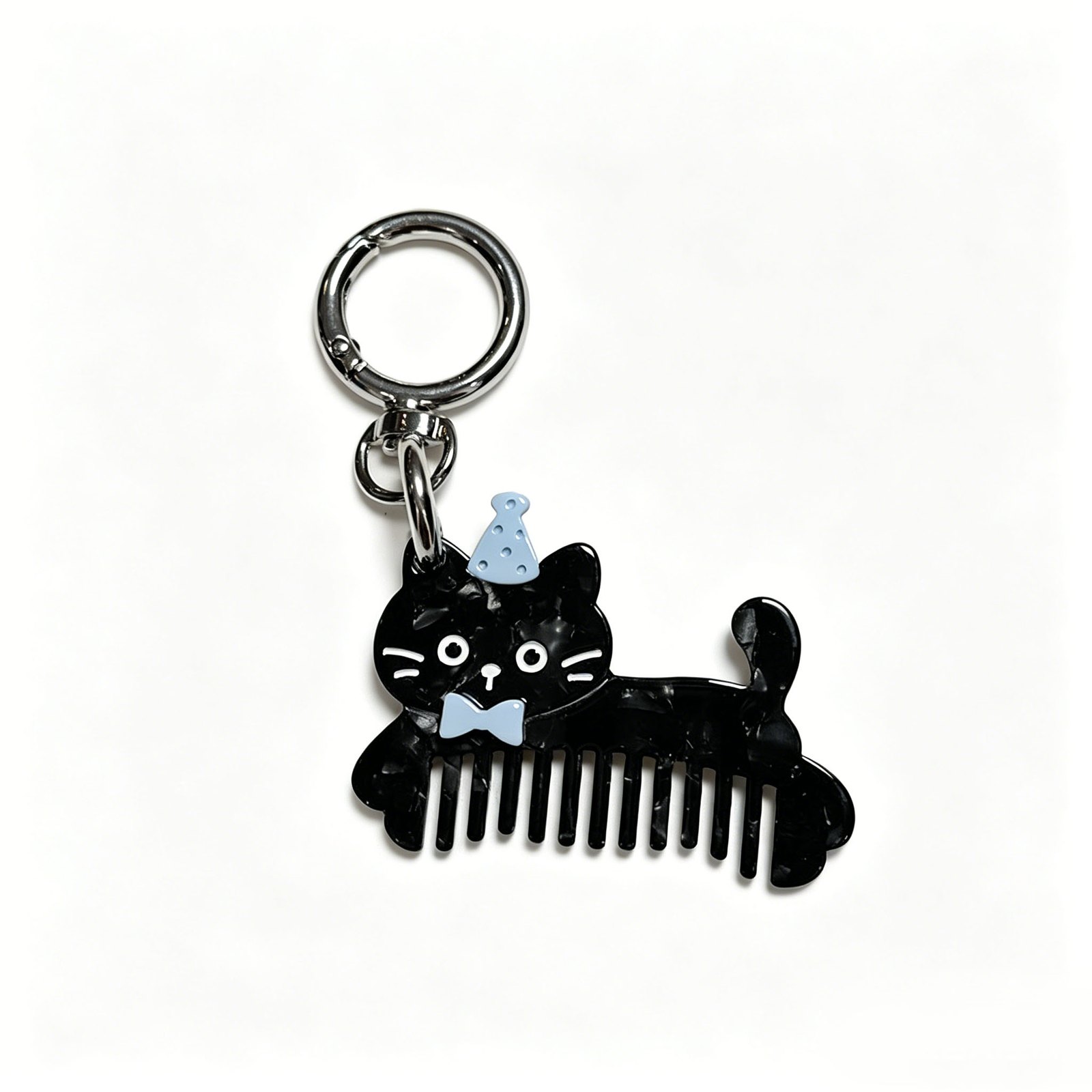 Cat-shaped comb charm with hat and round ring in black, white, blue, silver-tone, shown as a keychain.