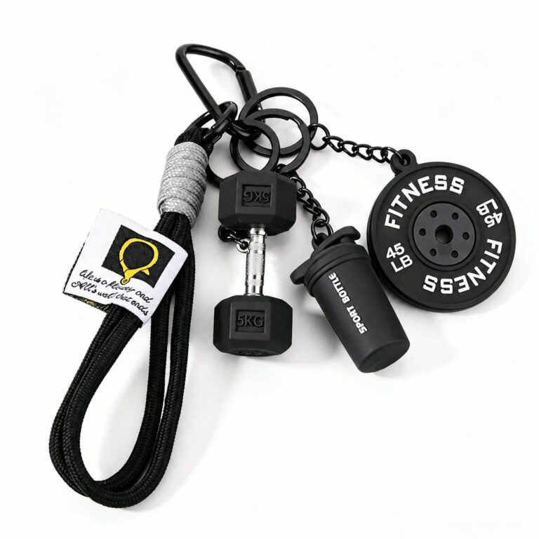 Black fitness charm set with weight-plate, dumbbell and bottle shapes, a wrist loop and carabiner