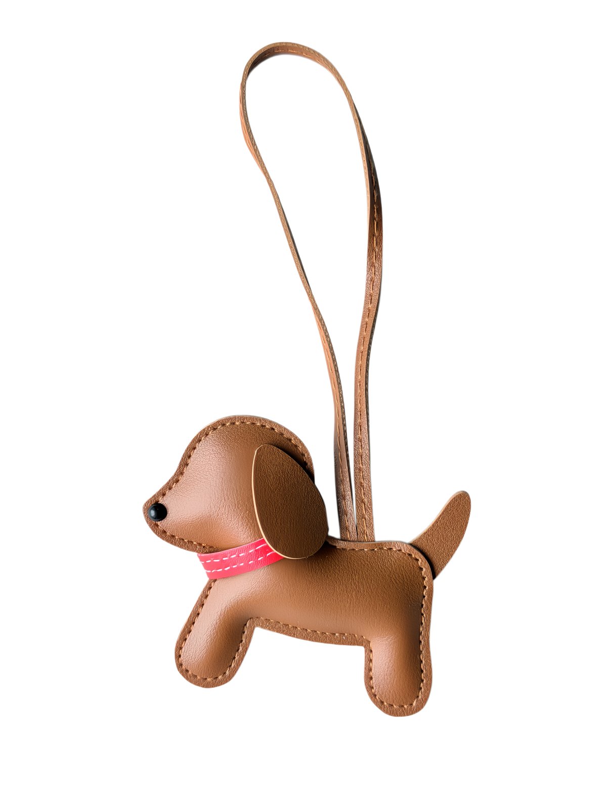 Dog-shaped padded charm with collar and long loop in tan, brown, pink, shown as a decorative hanging charm.