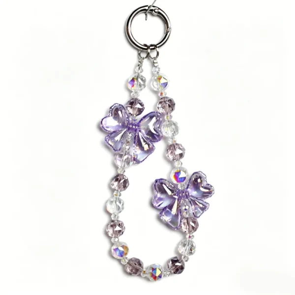 Purple beaded phone charm with translucent four-lobed accents and a round clasp