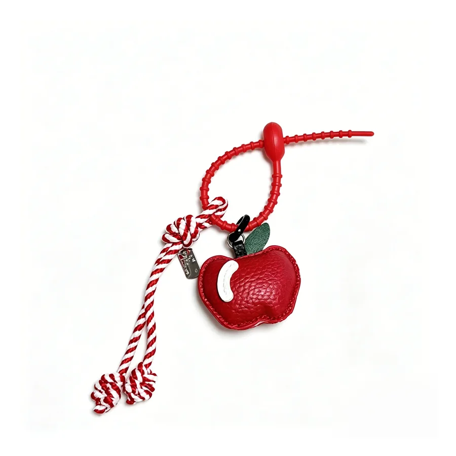 Custom tumbler and bottle charm with PVC apple detail for drinkware brands and gift programs.