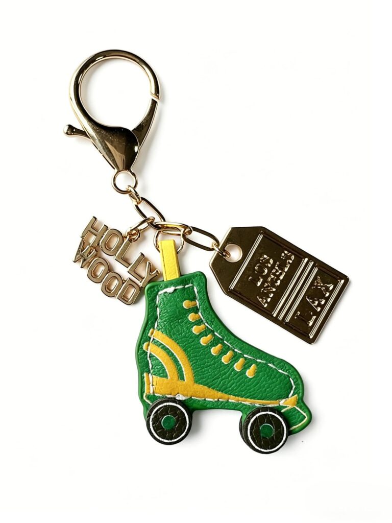 Green roller-skate charm keychain with yellow laces and gold-tone hardware