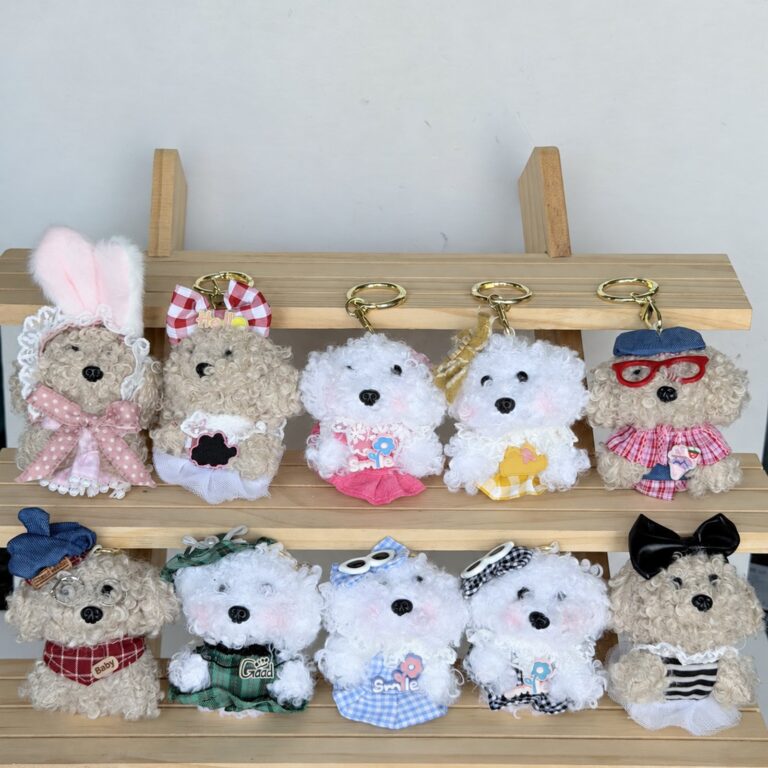 Mini plush animal bag charms in two rows on a wooden display