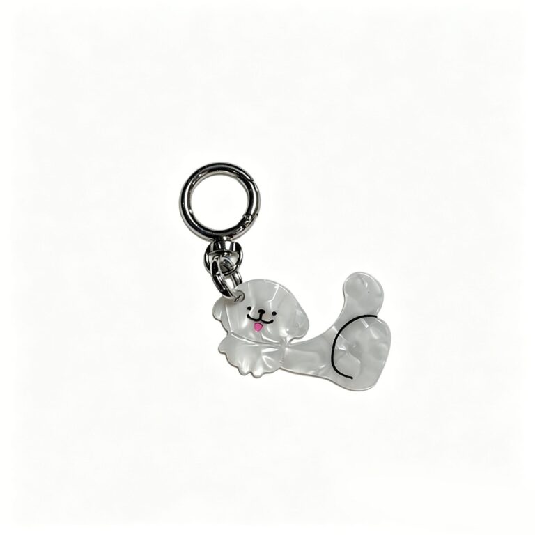 Pearl-white dog-shaped bag charm with a smiling face and silver-tone ring