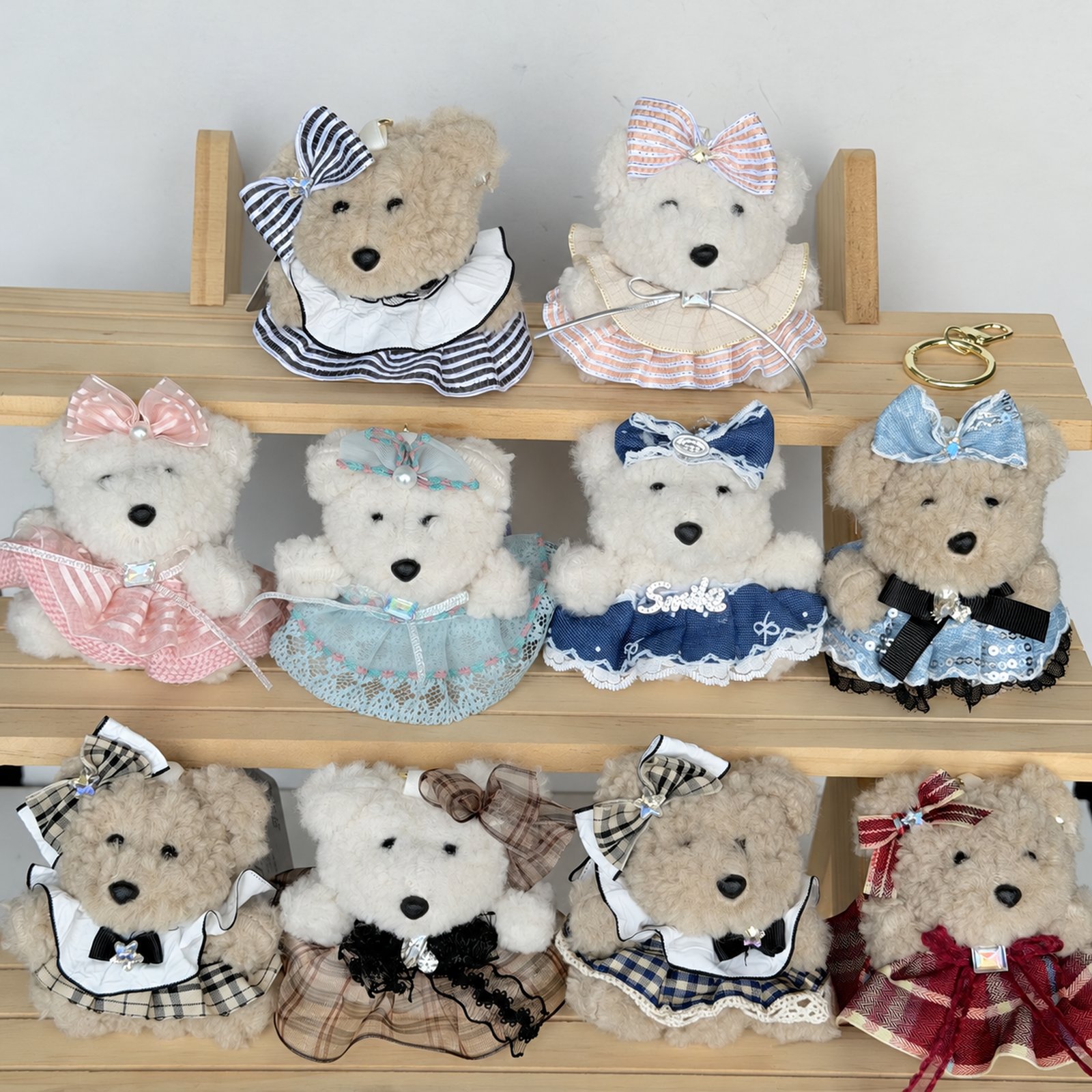 Ten dressed fuzzy animal charms with bows on display