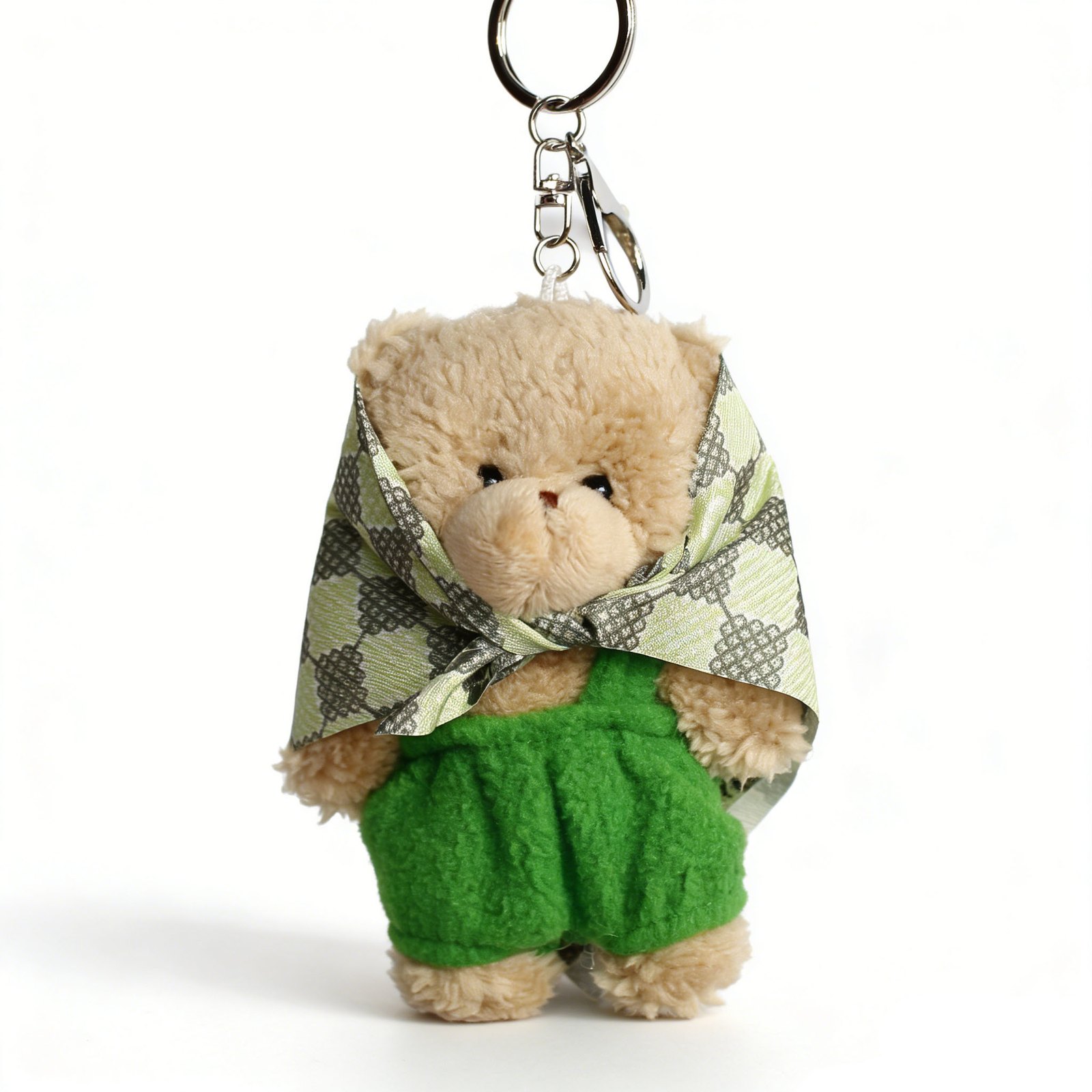 Fuzzy bear wearing headscarf and trousers with round ring in tan, green, cream, silver-tone, shown as a keychain.