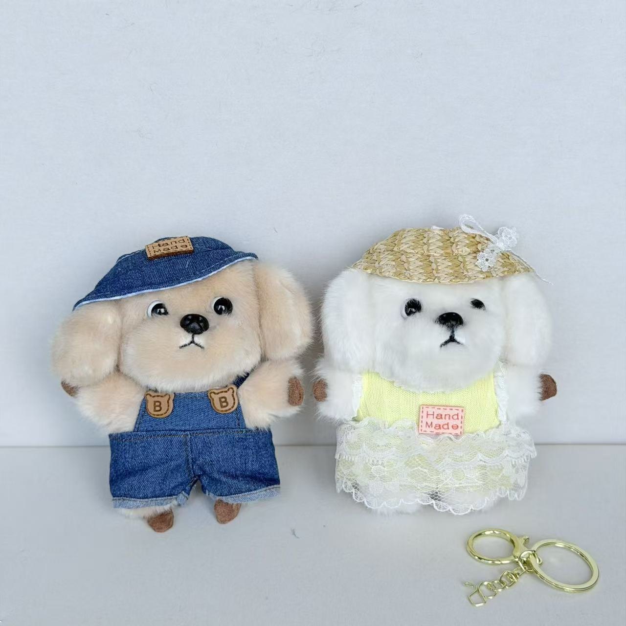 Two fuzzy dog charms with hats and outfits