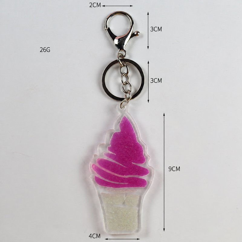 Soft-serve cone-shaped pendant with chain, ring and clip in pink, cream, clear, silver-tone, shown as a keychain.