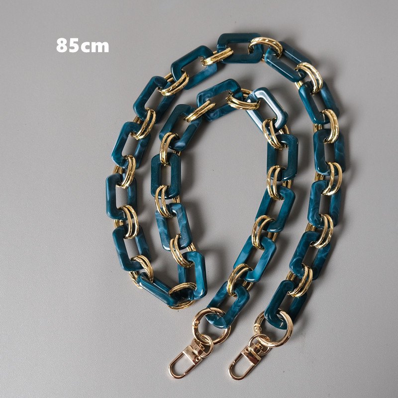 Long teal rectangular-link strap with gold-tone connectors