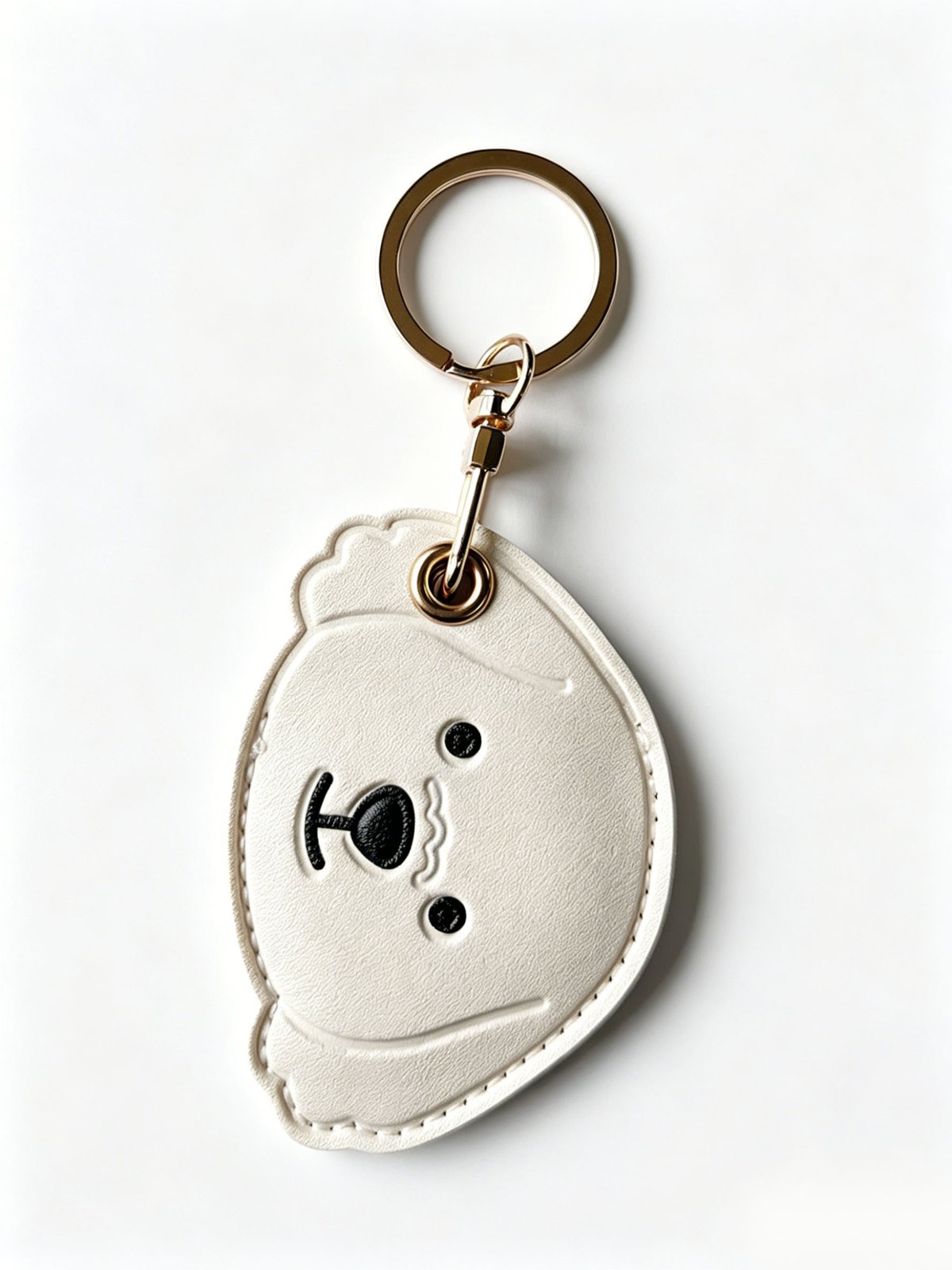 Bear face charm with round ring in cream, black, gold-tone, shown as a keychain.