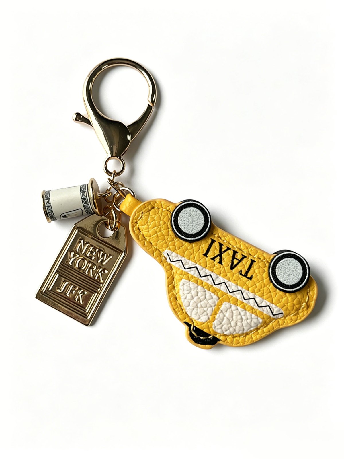 Yellow taxi-shaped keychain with a gold-tone clasp and rectangular tag