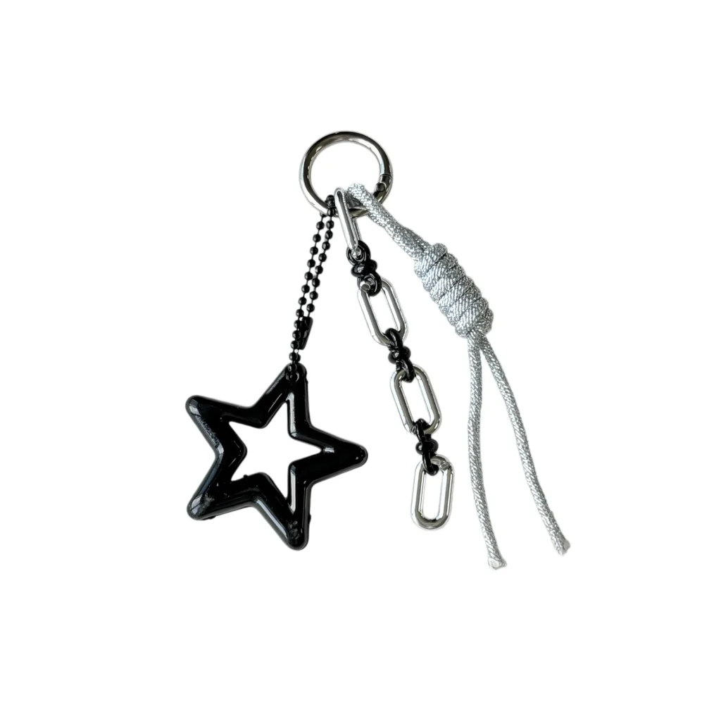 Open star charm with rectangular-link chain and knotted cord tails and ring in black, white, gray, silver-tone, shown as a keychain.