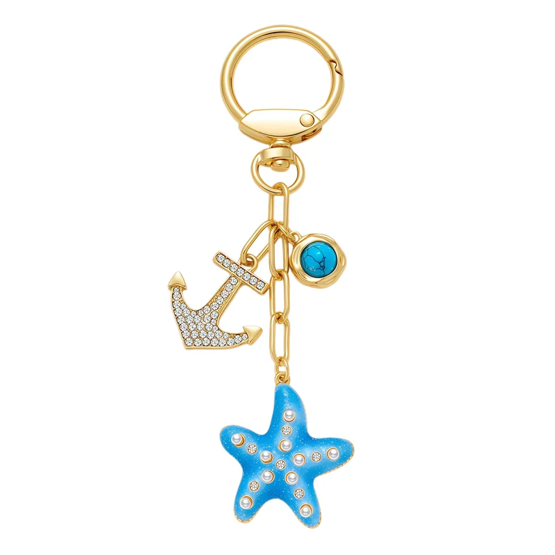 Blue starfish and anchor-shaped charms with a blue round accent, rectangular chain links and a circular gold-tone clasp