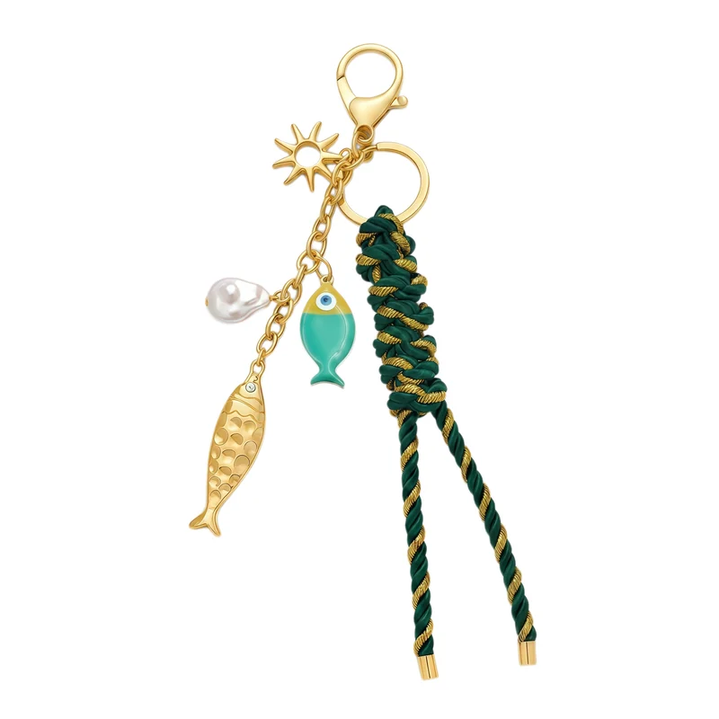 Two fish-shaped charms, a sun shape and a white bead with green-and-gold braided cord, chain, ring and clasp
