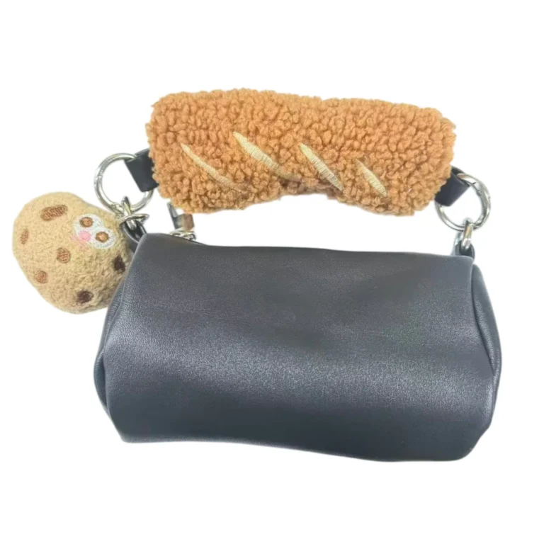 Gray cylinder pouch with fuzzy handle and cookie charm