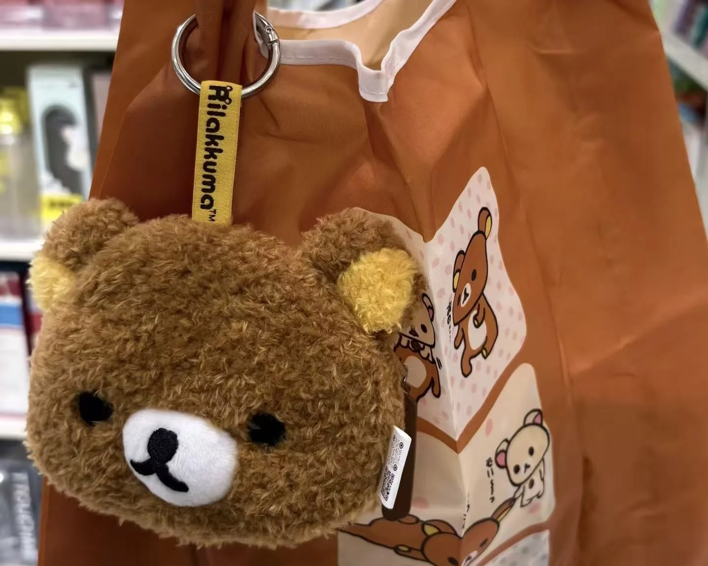 Plush mascot bag charm attached to a backpack for character merchandise