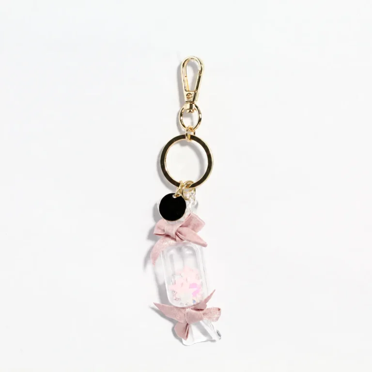 Pink wrapped-candy-shaped keyring with bow accents