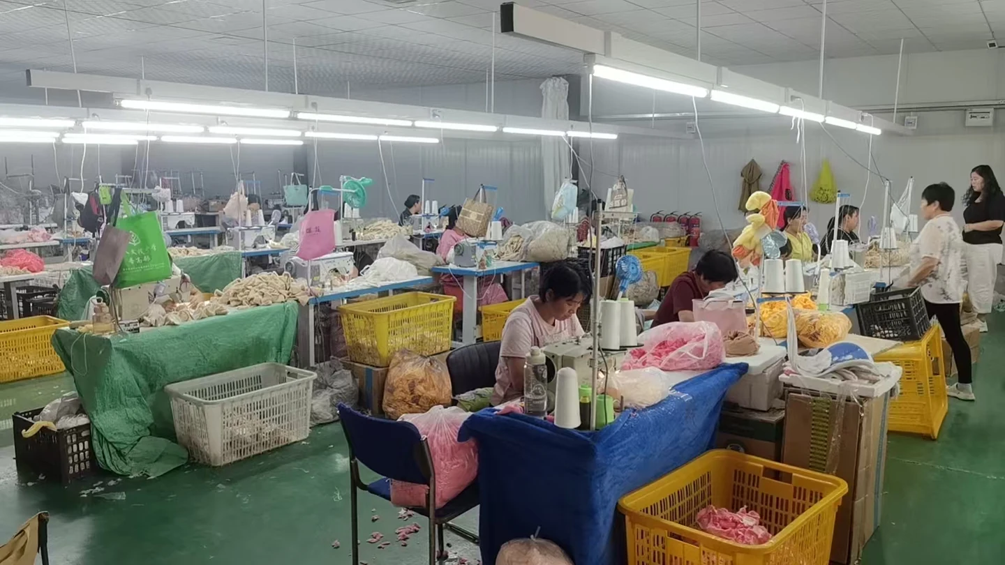 Sewing stations and handling bins in the plush production photo archive