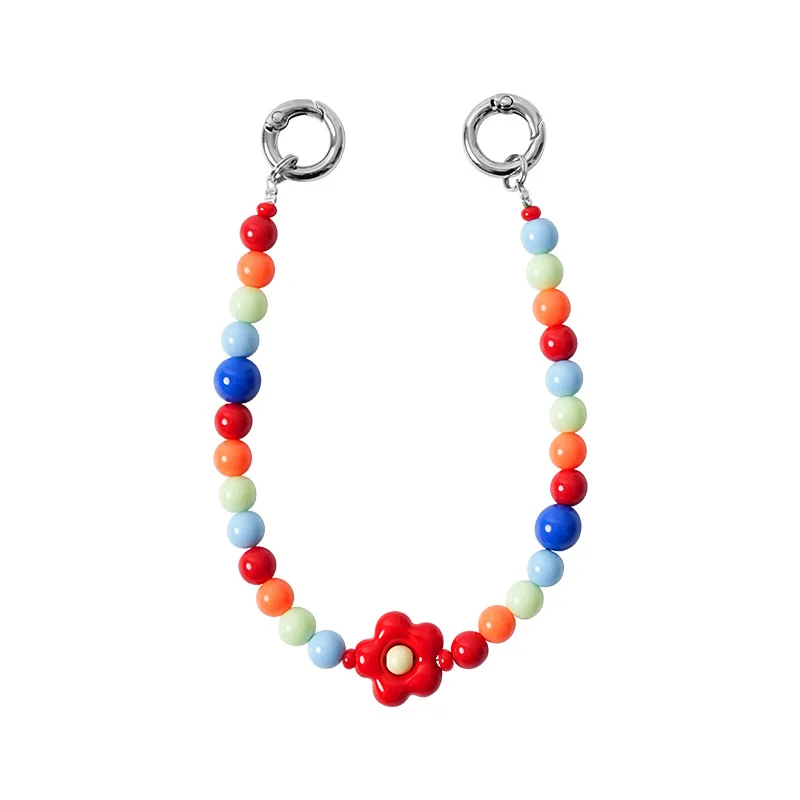 Rainbow round beads and a red flower piece between two silver-tone round clips.