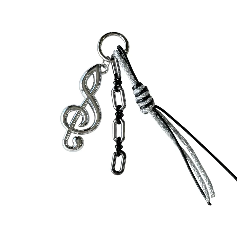 Silver-tone treble-clef charm with dark rectangular links, a circular ring and knotted black-and-silver cord