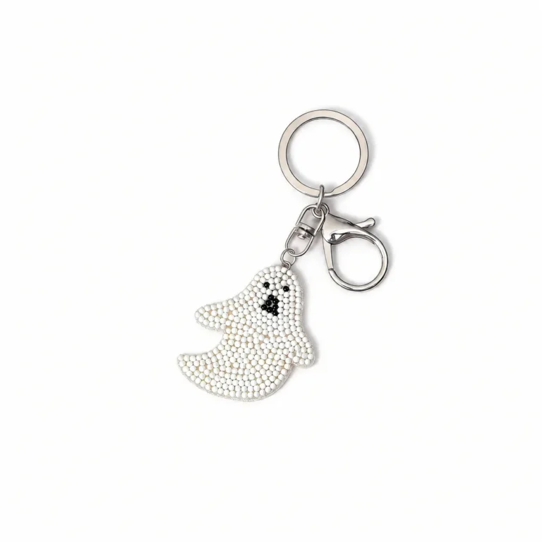 Beaded ghost charm with clasp and round ring in white, black, silver-tone, shown as a keychain.