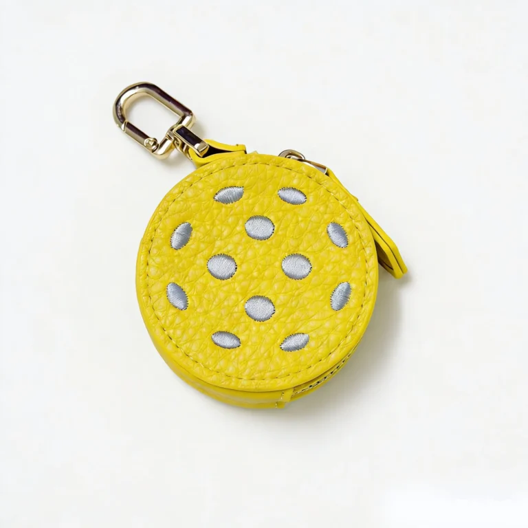 Yellow perforated-ball coin purse keychain